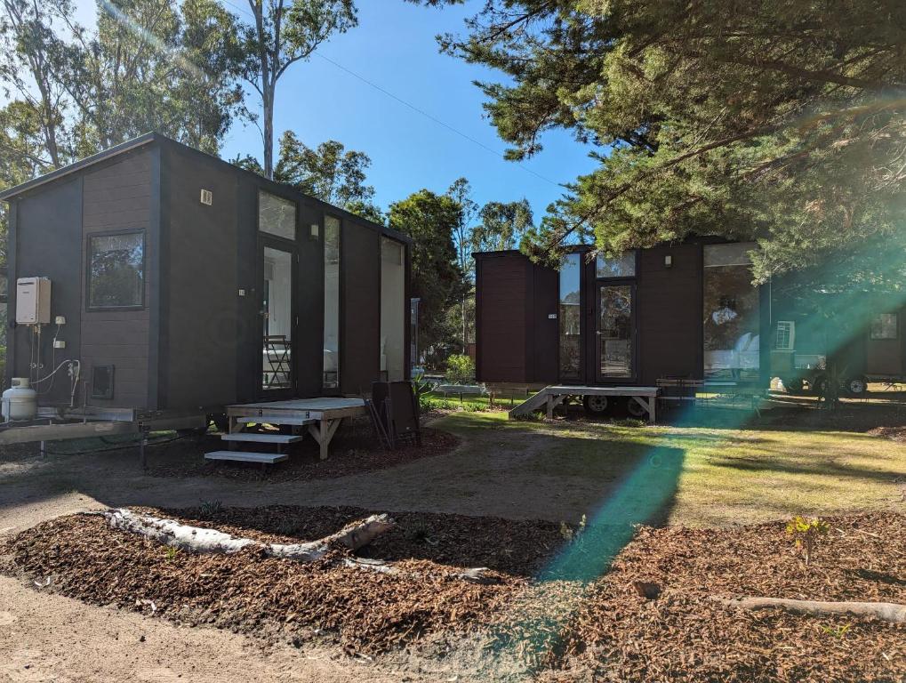 a tiny house sitting on top of a yard at Tiny House 16A at Grampians Edge in Dadswells Bridge