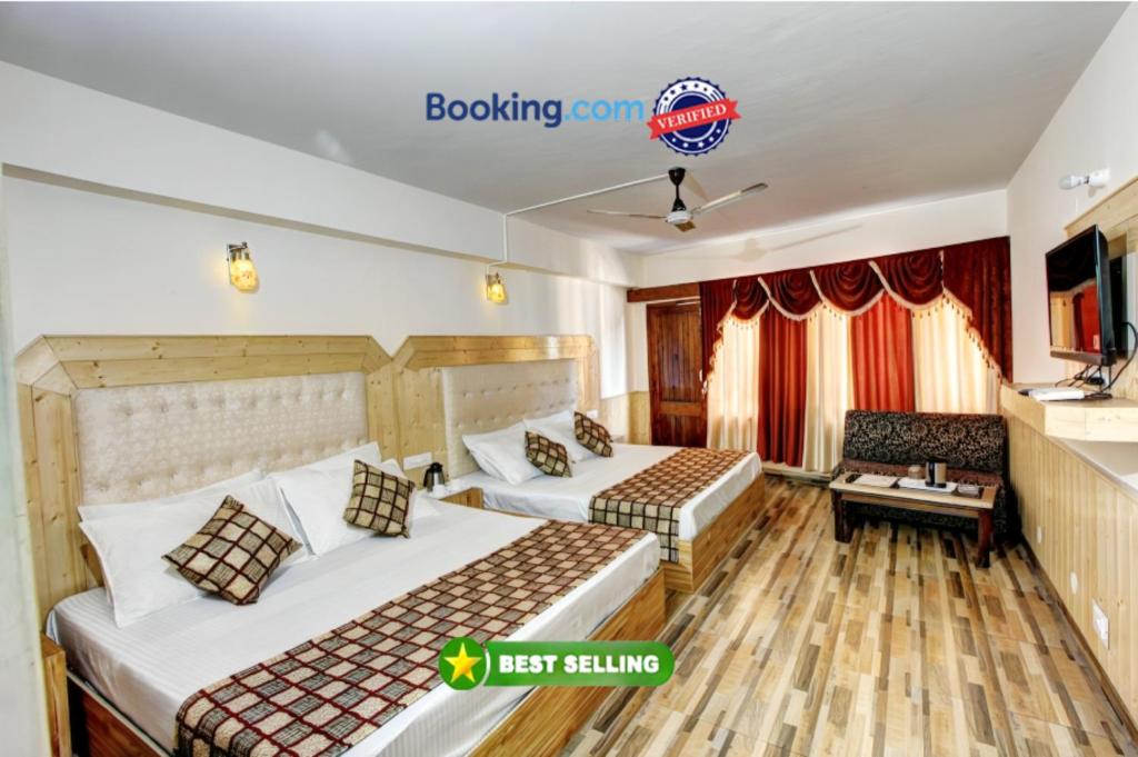 a hotel room with two beds and a couch at Hotel Highway Inn Manali - Luxury Stay - Excellent Service - Parking Facilities in Manāli