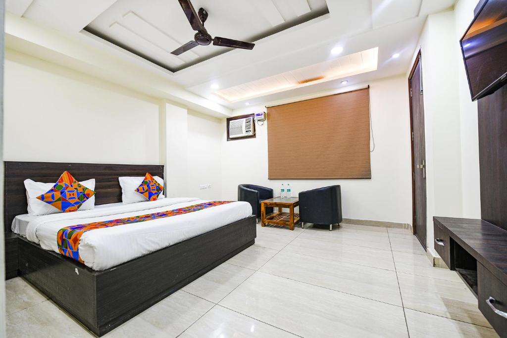 FabHotel Dwarka Residency في نيودلهي: غرفة نوم بسرير وشاشة عرض