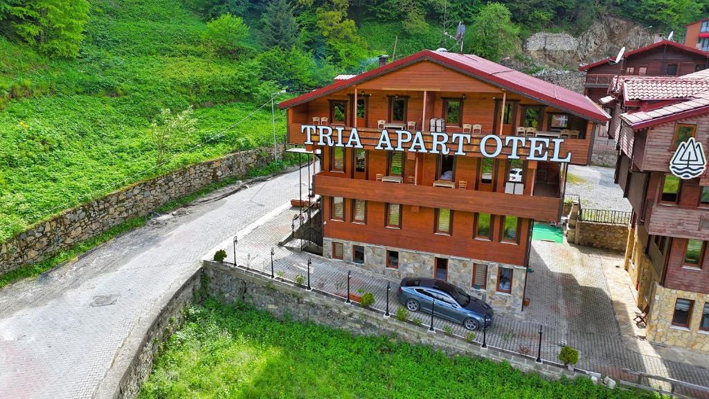 a building with a car parked in front of it at TRIA APART OTEL in Uzungöl