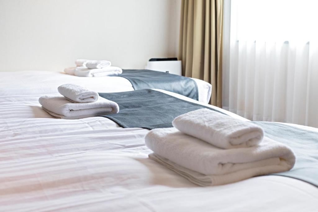 Postel nebo postele na pokoji v ubytování WONZ HOTEL 島之内道顿堀心斎橋難波エリア中心地 New Open Sale