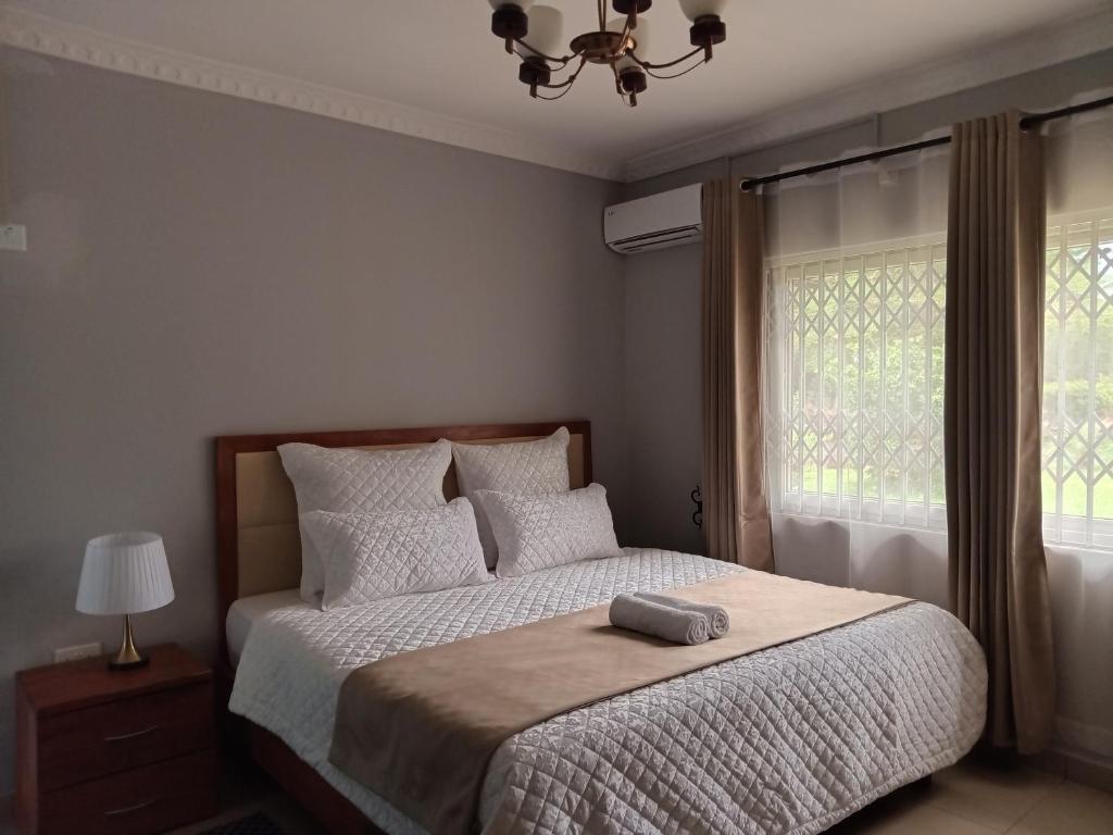 a bedroom with a bed with a pillow on it at Nangoma Safari Lodge Lusaka in Lusaka
