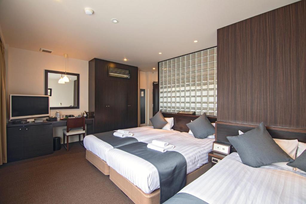 Postel nebo postele na pokoji v ubytování WONZ HOTEL 島之内道顿堀心斎橋難波エリア中心地 New Open Sale