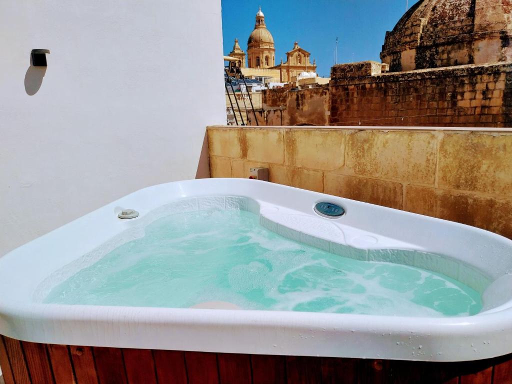 a bath tub sitting on top of a building at Pjazza Suites Boutique Hotel by CX Collection in Siġġiewi