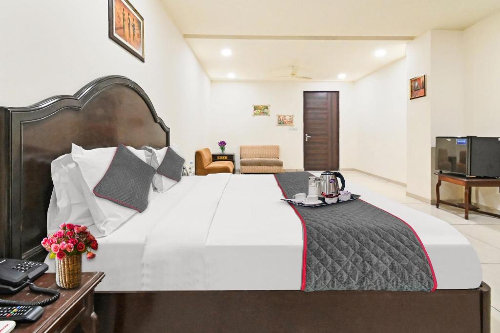 a hotel room with a large bed and a desk at OYO Townhouse 998 Hotel Monark in Jaipur
