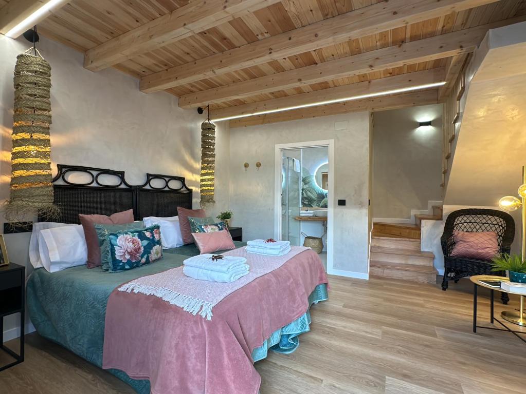 a bedroom with a bed in a room with wooden ceilings at Conde Dúplex - Casal do Conde in Caldas de Reis