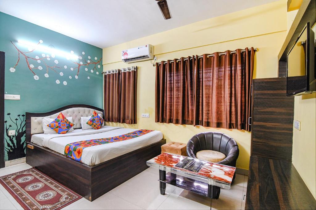 a hotel room with a bed and a chair at FabHotel Eco Inn in kolkata