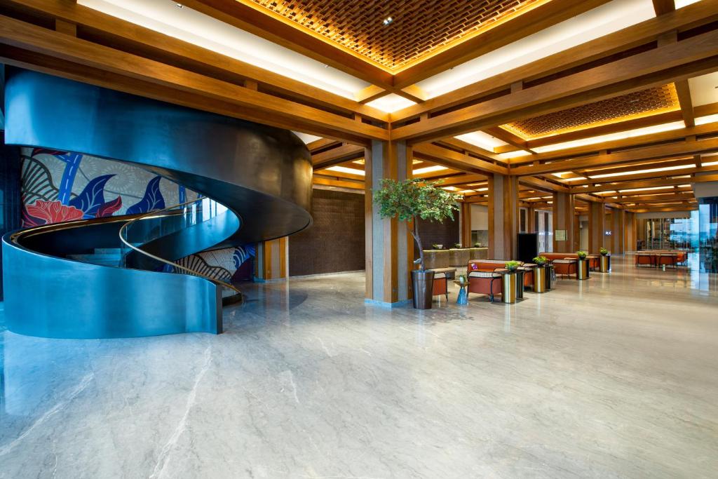 a lobby with a spiral staircase in a building at MORAZEN Yogyakarta in Temon