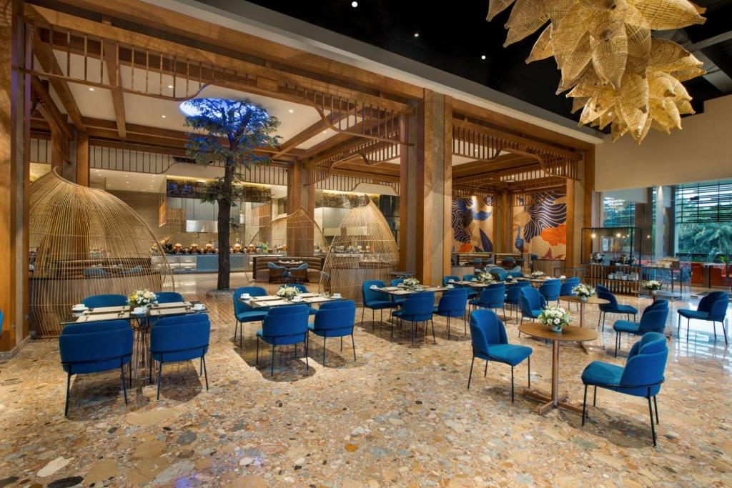 a restaurant with blue chairs and tables at MORAZEN Yogyakarta in Temon
