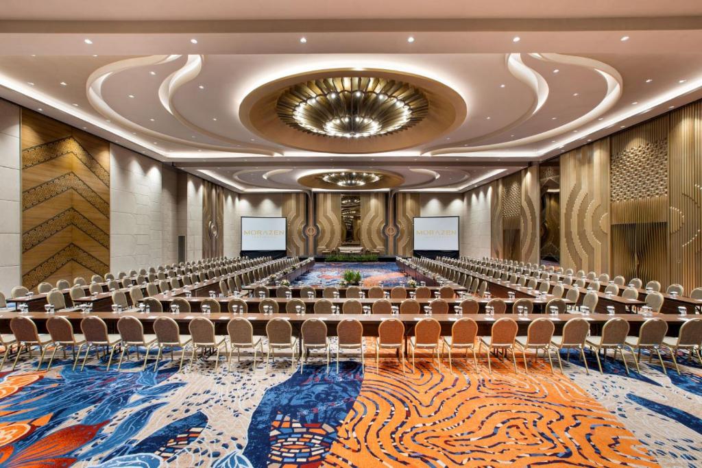 an empty conference room with chairs and a stage at MORAZEN Yogyakarta in Temon
