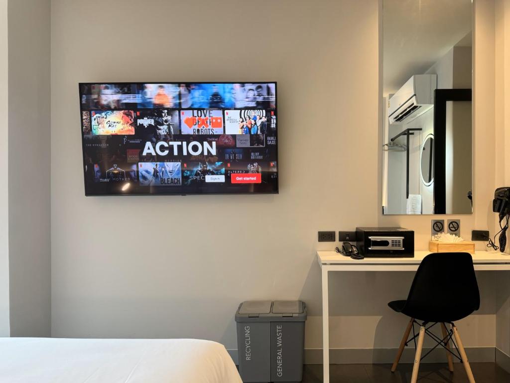 A compact in-room desk beneath a wall-mounted television.