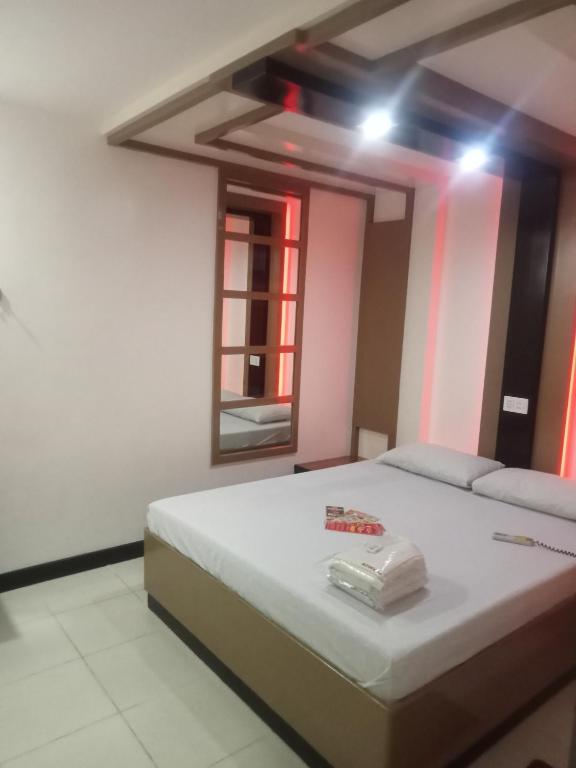 Postel nebo postele na pokoji v ubytování Hotel Sogo Cabanatuan