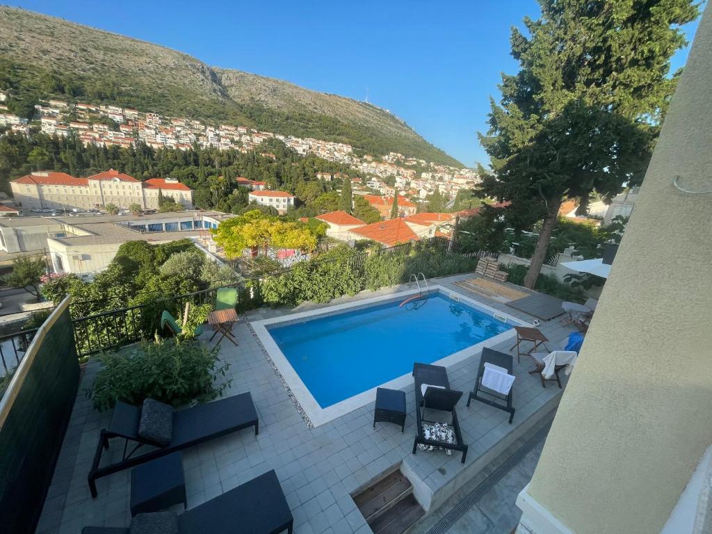 an overhead view of a swimming pool with a mountain at Mediteraneo in Dubrovnik