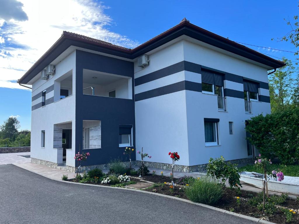 a blue and white building on the side of a road at Althea Home & Wellness in Bihać