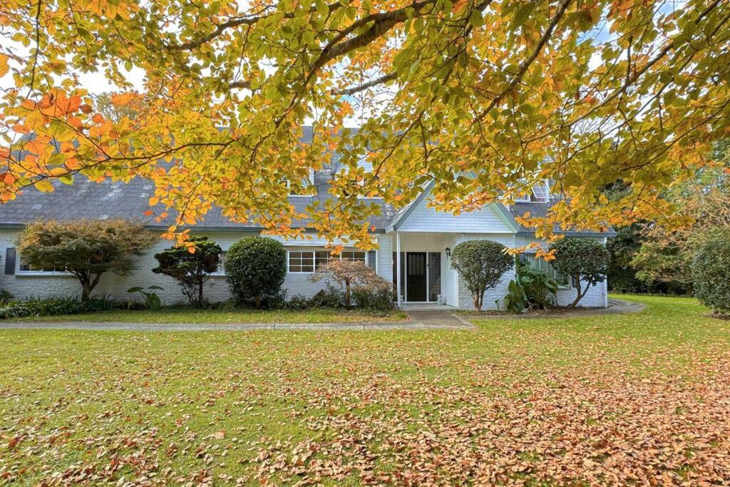 a white house with a tree in front of it at 5Rooms life-style in City—“Golden Harvest Retreat” in Matangi