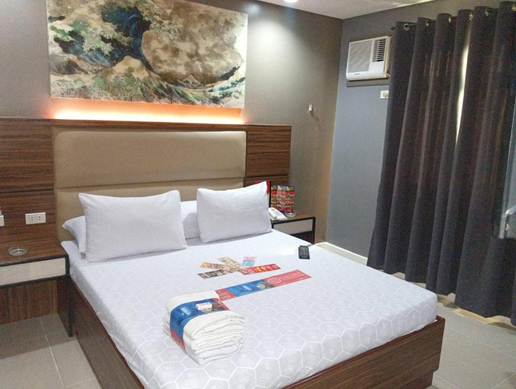 Ліжко або ліжка в номері Hotel Sogo Timog 2