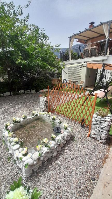 a garden with a circle of rocks and plants at George house in Leonidion