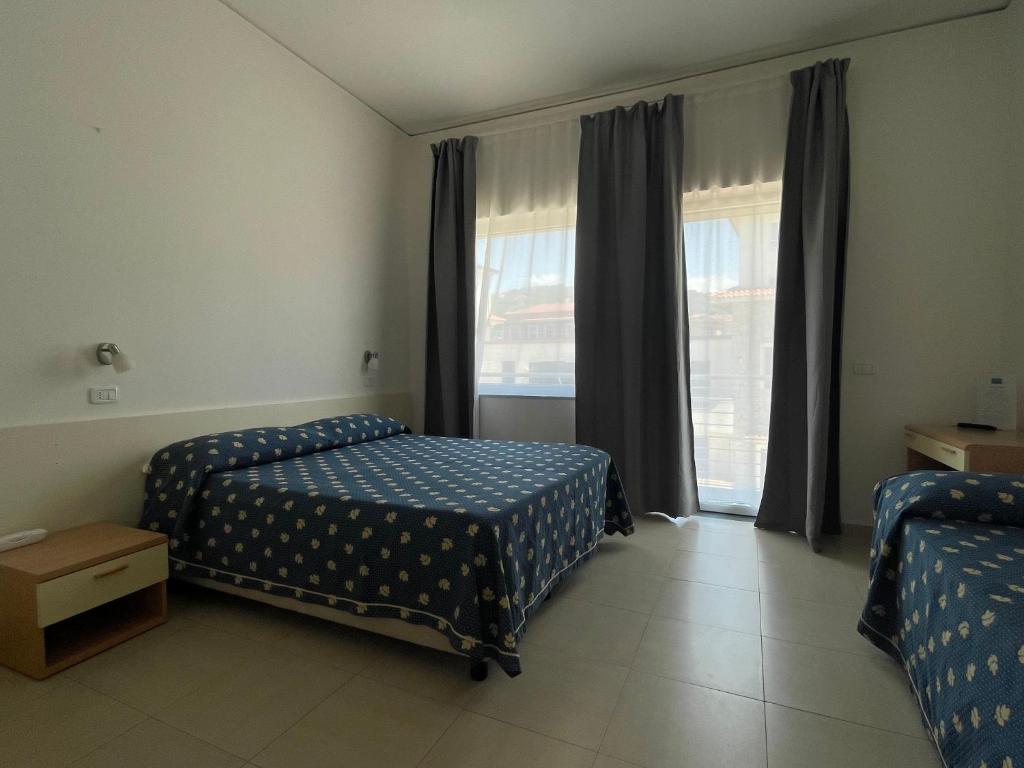 Postel nebo postele na pokoji v ubytování Hotel Mare