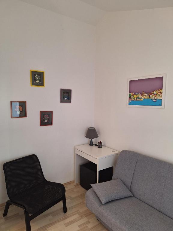 a living room with a couch and a desk at Pension Oaza in Hvar
