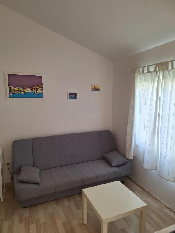 a living room with a couch and a table at Pension Oaza in Hvar