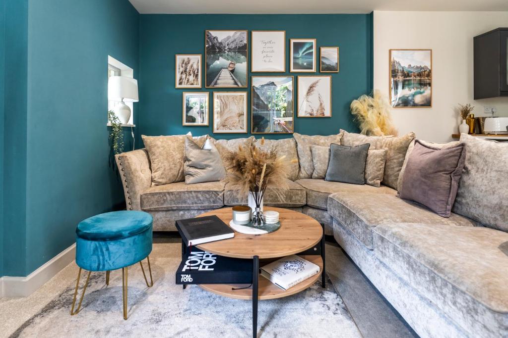 a living room with a couch and a table at Spring Mount Huge Luxury Full Apartment- Harrogate Centre-Two extremely comfy Kingsize Bedrooms-Fully equipped Modern Kitchen-Cosy living room with Huge TV in Harrogate