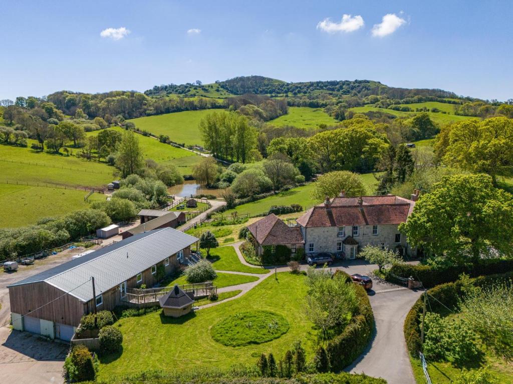 an aerial view of a farm with a building at Godshill Park Cottages in Godshill