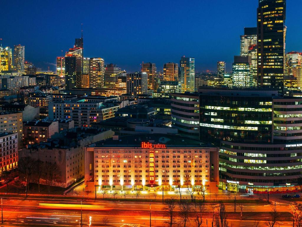 a view of a city at night with at ibis Warszawa Centrum in Warsaw