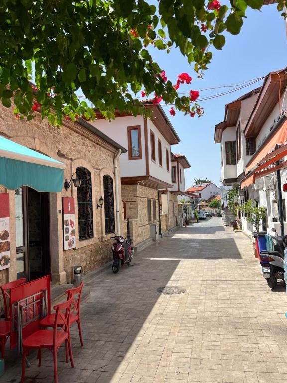 a street in a town with red chairs and buildings at Sabah Homes in Antalya