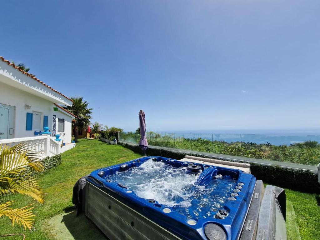 a hot tub in the backyard of a house at Escape to Finca Conejo, Typical Canarian House private jacuzzi, sauna, gym, Finca Conejo Taucho by Aqua Vista Tenerife in Adeje