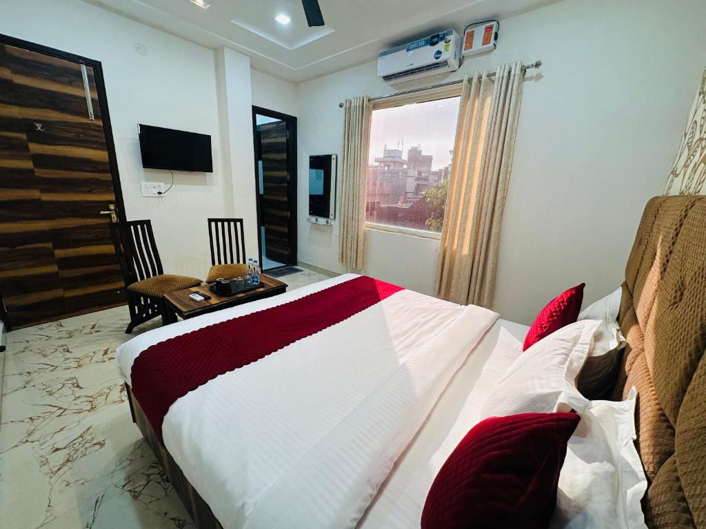 a hotel room with a bed and a window at Embasy Hotel Near Golden Temple in Amritsar