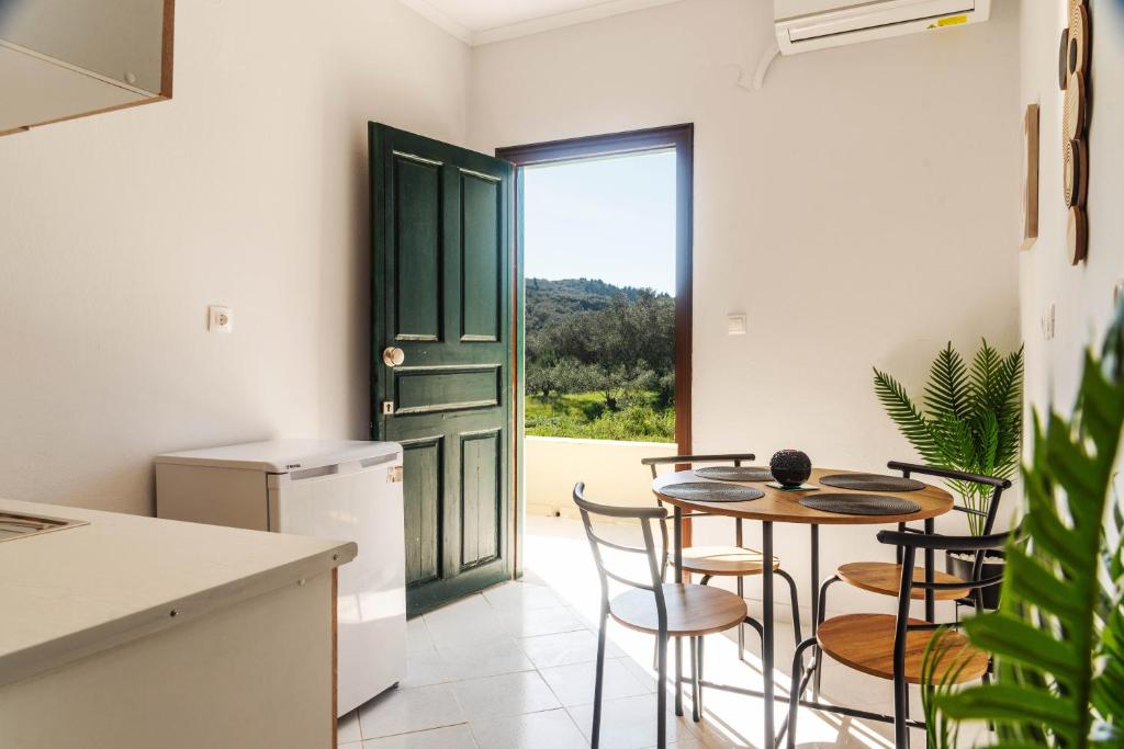 a kitchen and dining room with a table and chairs at ELPIS appartment in Vitalades