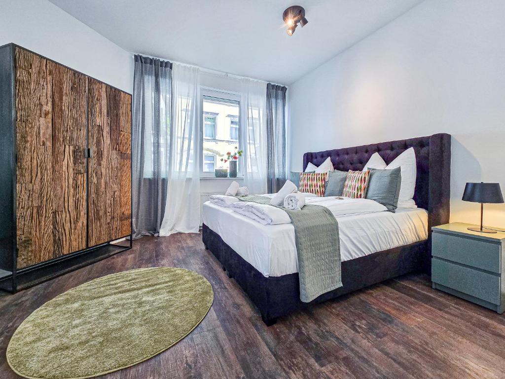 a bedroom with a large bed and a large window at Alpha Apartments in Dortmund