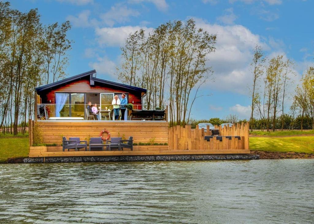 a house on a floating dock on a lake at Noahs Retreat in Laceby