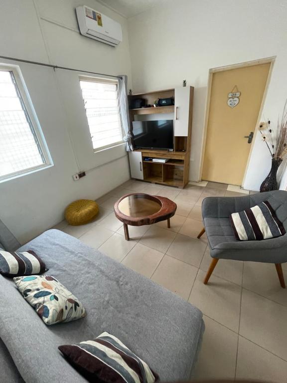 uma sala de estar com um sofá e uma mesa em Big & confortable house in Oxford street Barnor em Acra
