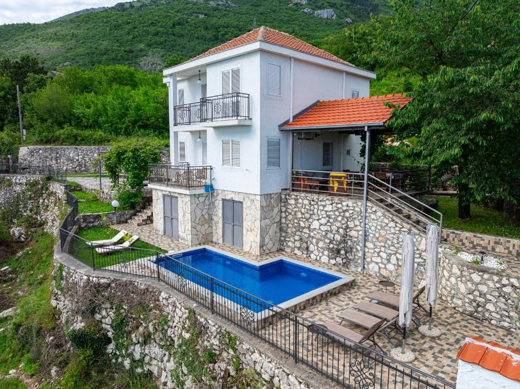 a house with a swimming pool in front of it at Villa Tranquila in Budva