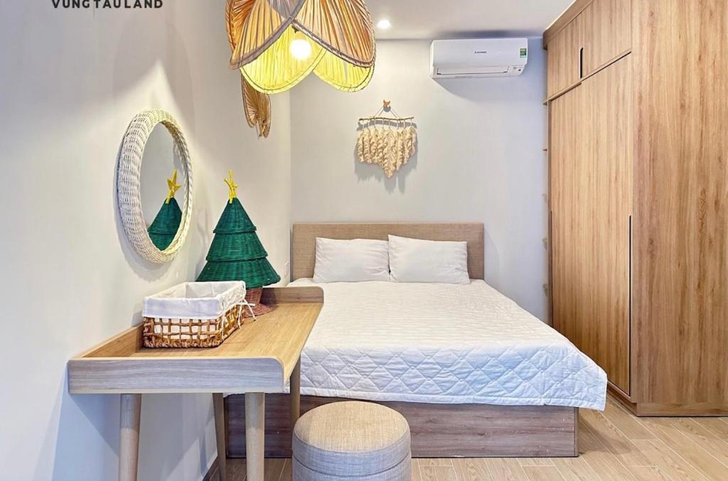 a small bedroom with a bed with a christmas tree on it at The Sóng Apartment Vũng Tàu - Hằng Homestay in Vung Tau