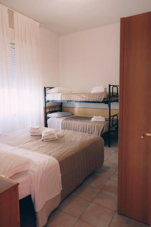 Postel nebo postele na pokoji v ubytování Hotel Enna Rimini