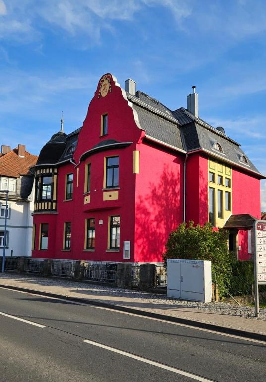 a red building on the side of a street at Wohlfühl-Villa in Themar in Themar