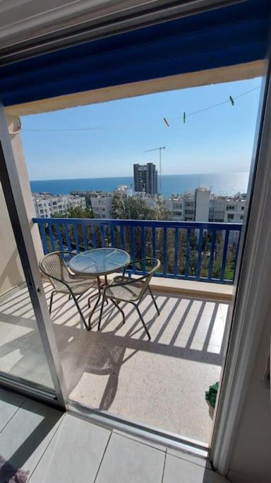 a view of a balcony with a table and a chair at Peaceful Beach Location in Limassol