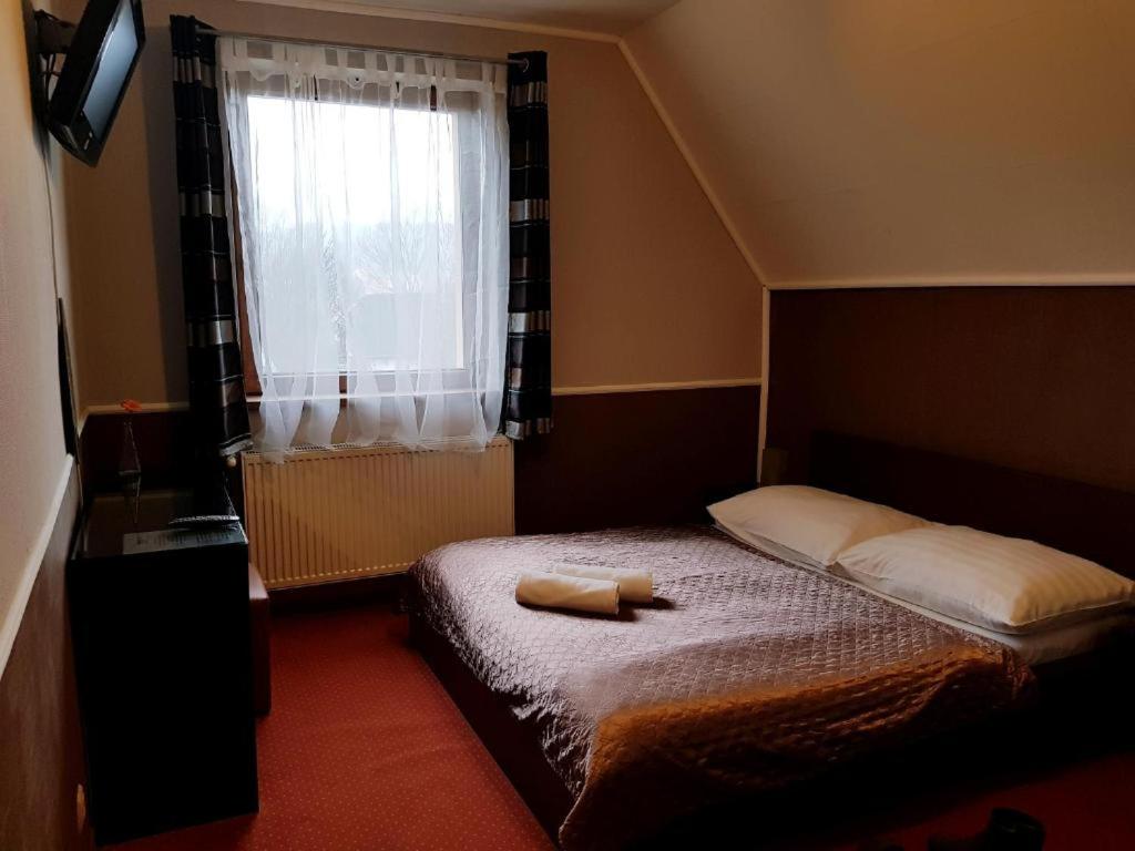 Postel nebo postele na pokoji v ubytování Amaretto Szállás