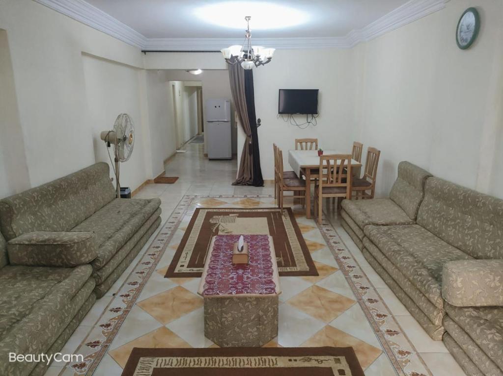 a living room with two couches and a table at Downtown Sea View Suites in Alexandria