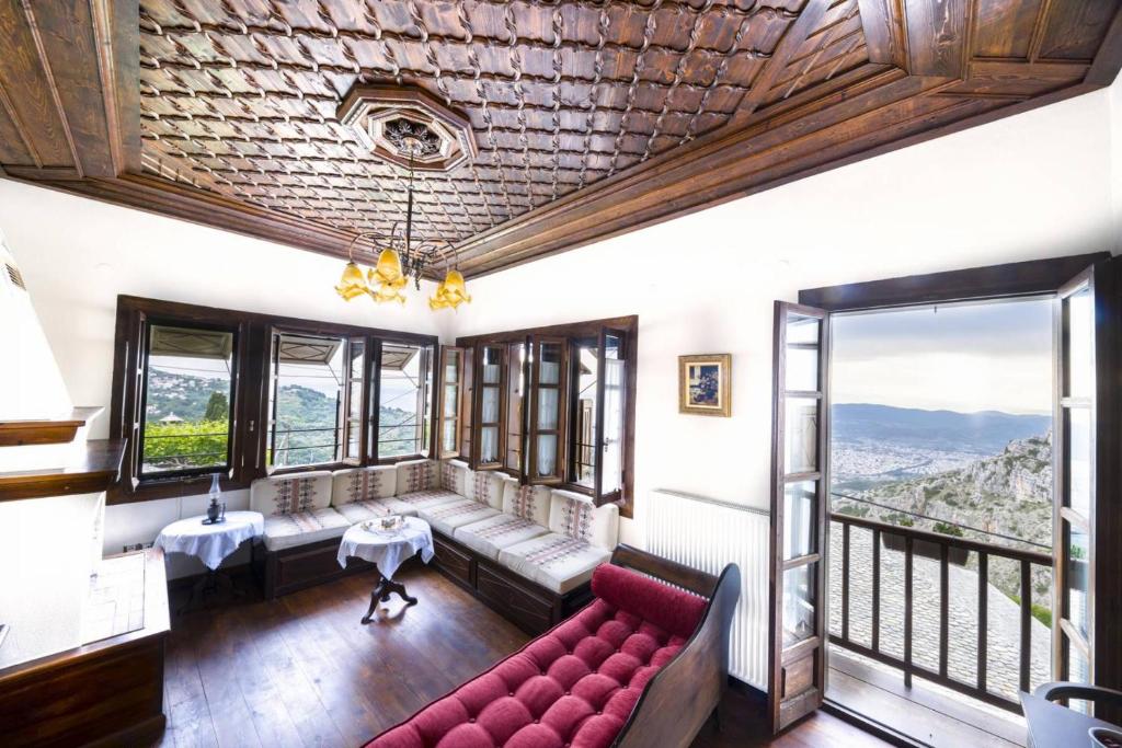 a living room with a couch and a table at Ινω Superior Suite 1856 Makrinitsa Pelion in Makrinitsa