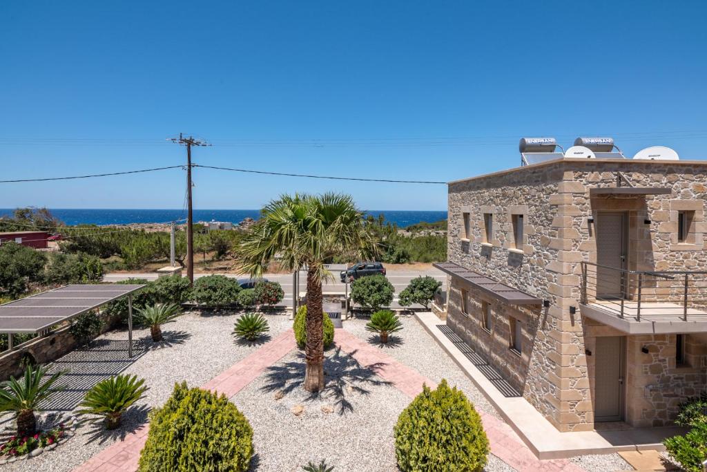 an exterior view of a stone building with a courtyard at Xasteria in Elafonisi