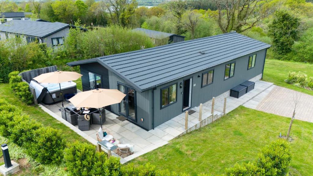 an overhead view of a tiny house with a patio at Iris Lodge, 18 Roadford Lake Lodges in Lifton