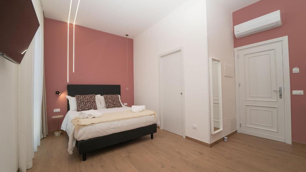 Postel nebo postele na pokoji v ubytování Manere Suites