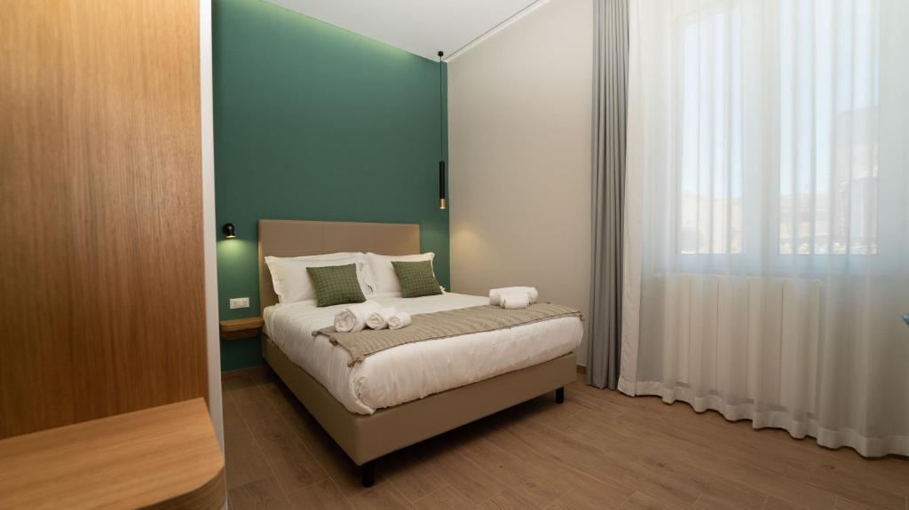 Postel nebo postele na pokoji v ubytování Manere Suites