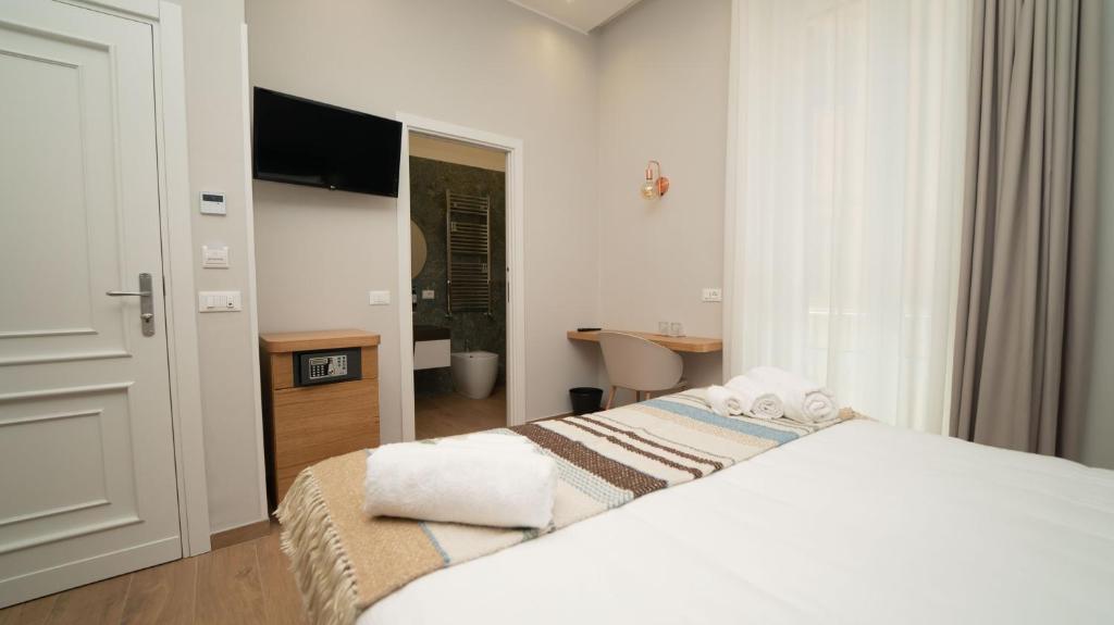 Postel nebo postele na pokoji v ubytování Manere Suites