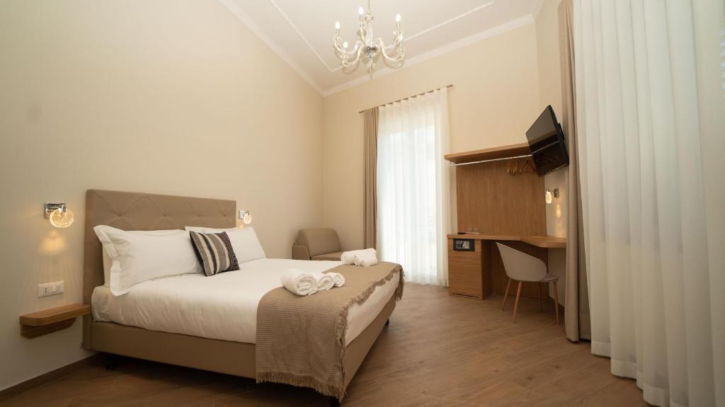 Postel nebo postele na pokoji v ubytování Manere Suites