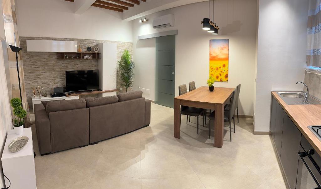 a kitchen and living room with a couch and a table at Onda di Porta a Mare in Livorno