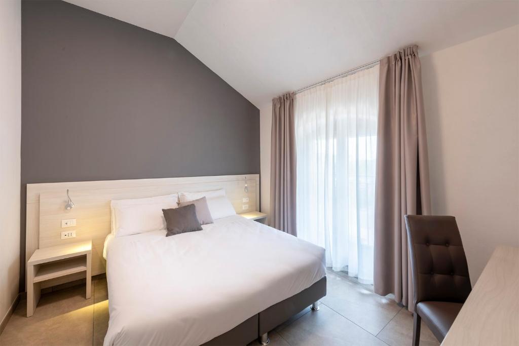 Postel nebo postele na pokoji v ubytování Hotel Vecchio Casello